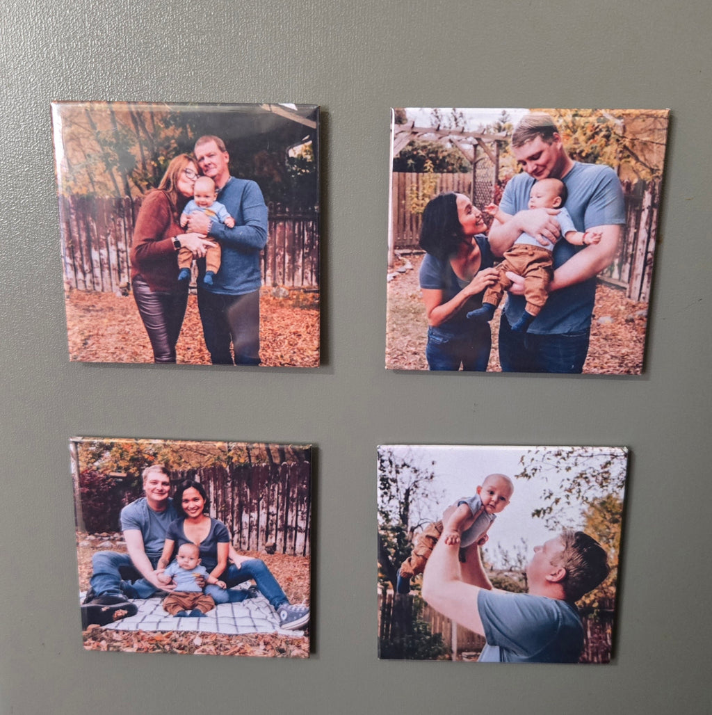 Four square photo magnets displaying family photos on a grey magnetic surface